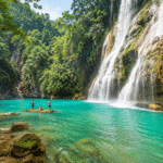 Tropical waterfall with bamboo boat